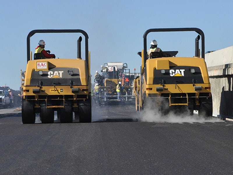 Pair of rollers on highway construction and paving project