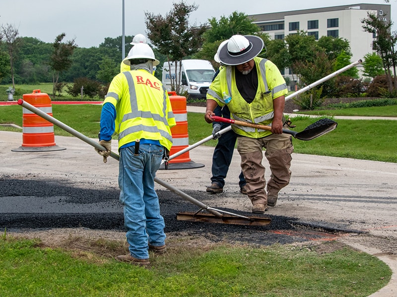 Asphalt paving contractor field personnel working on roadway construction project