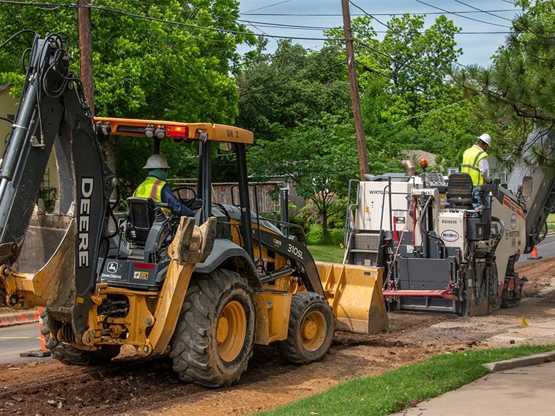 Equipment operator driving a wheel loader behind FDR machine